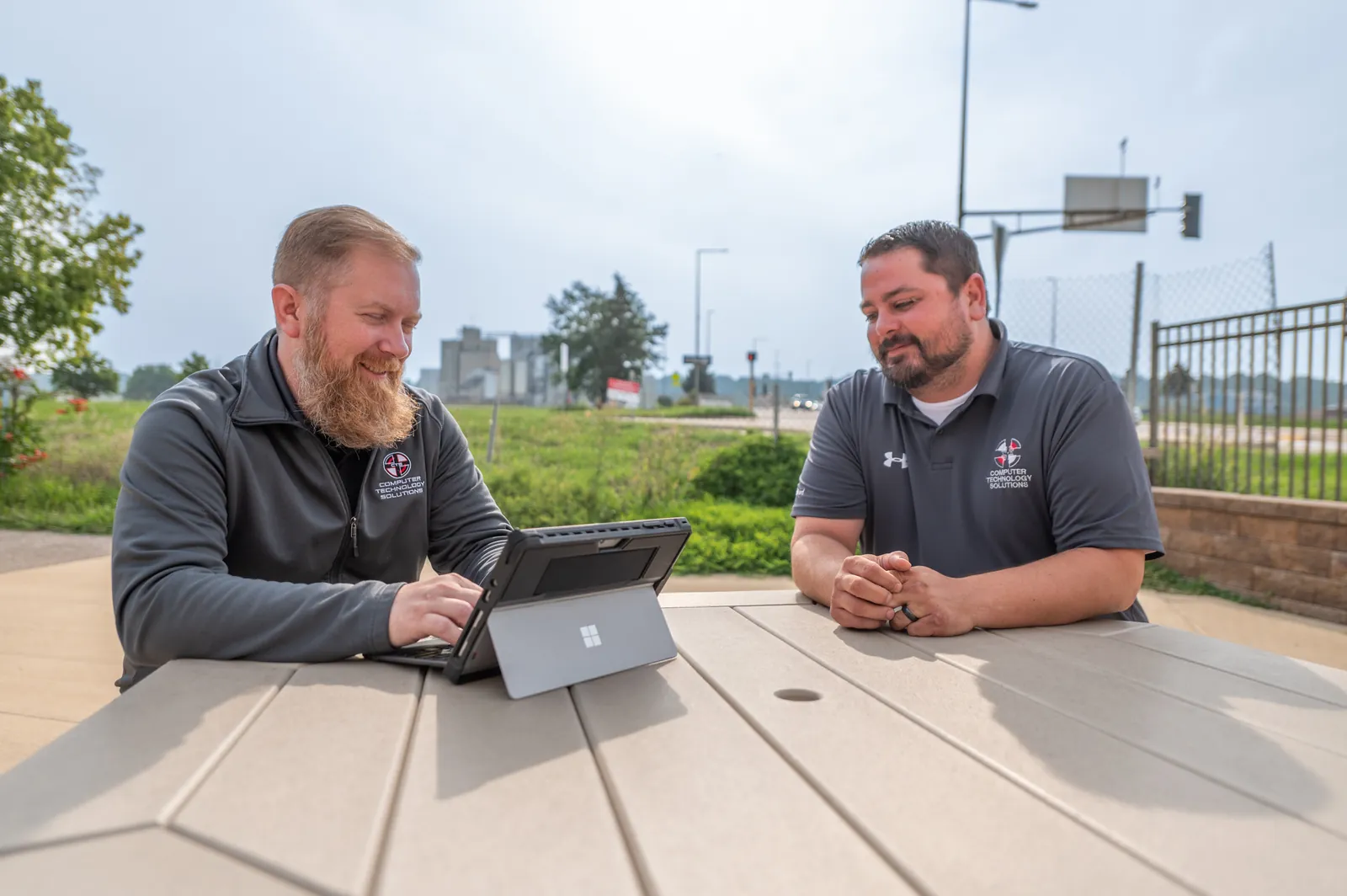 CTS team meeting in North Mankato CTS IT team reviewing technology plans outdoors in North Mankato